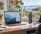 Student laptop, notebook, backpack and charger on a bright New Zealand campus study desk