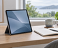 Illustrative tablet in a folio stand on a bright home-study desk beside a notebook